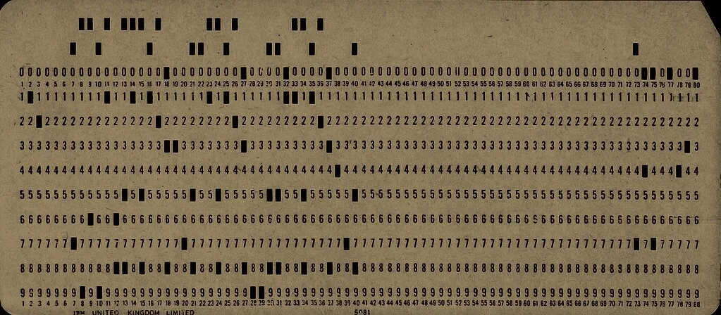 A used punched card, its columns clipped in rows